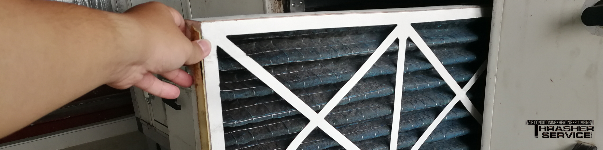 Untitled design - 2026-03-27T100851.355 Thrasher Service replacing an HVAC filter as part of an indoor air quality visit to a Des Moines metro home.