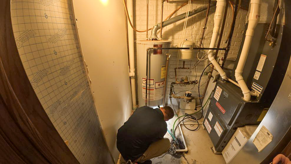 A Thrasher Service plumber begins a water heater replacement in Des Moines.